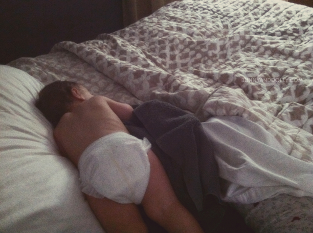 Toddler wearing diaper sick in bed