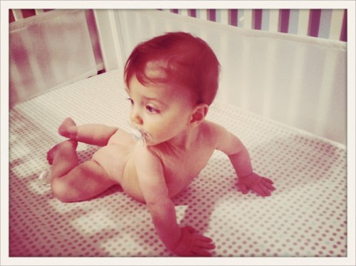 naked baby in crib