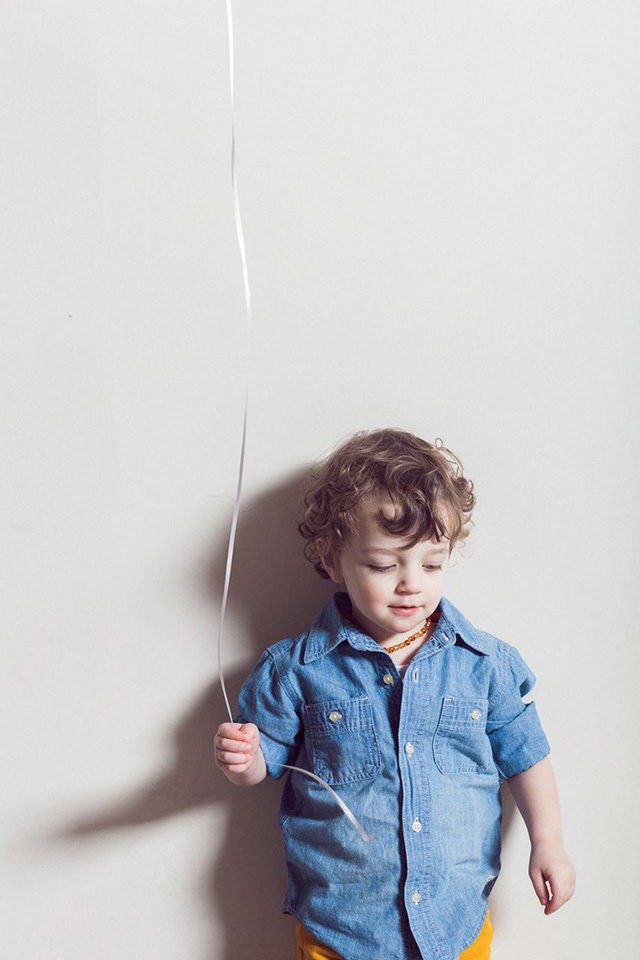 toddler holding balloon string
