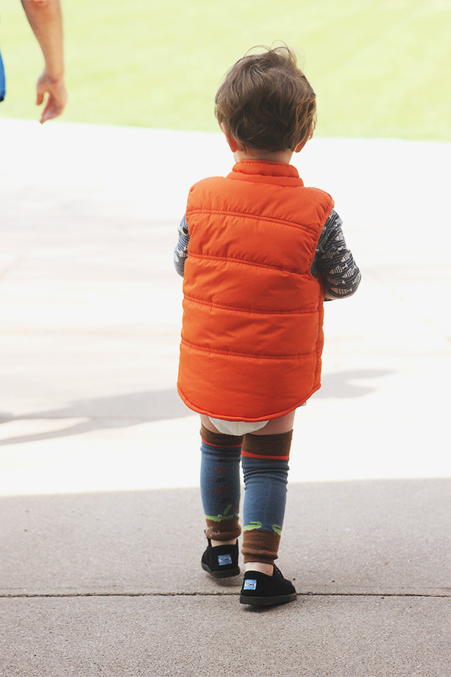 toddler wearing vest outside
