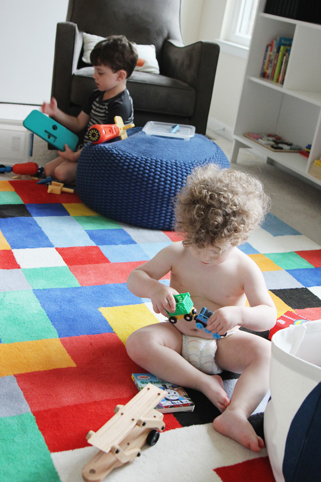 Brothers playing toys in their boys' shared bedroom