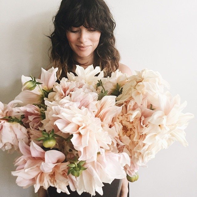 Hairstylist Rubi Jones with curly bangs and bleached ends